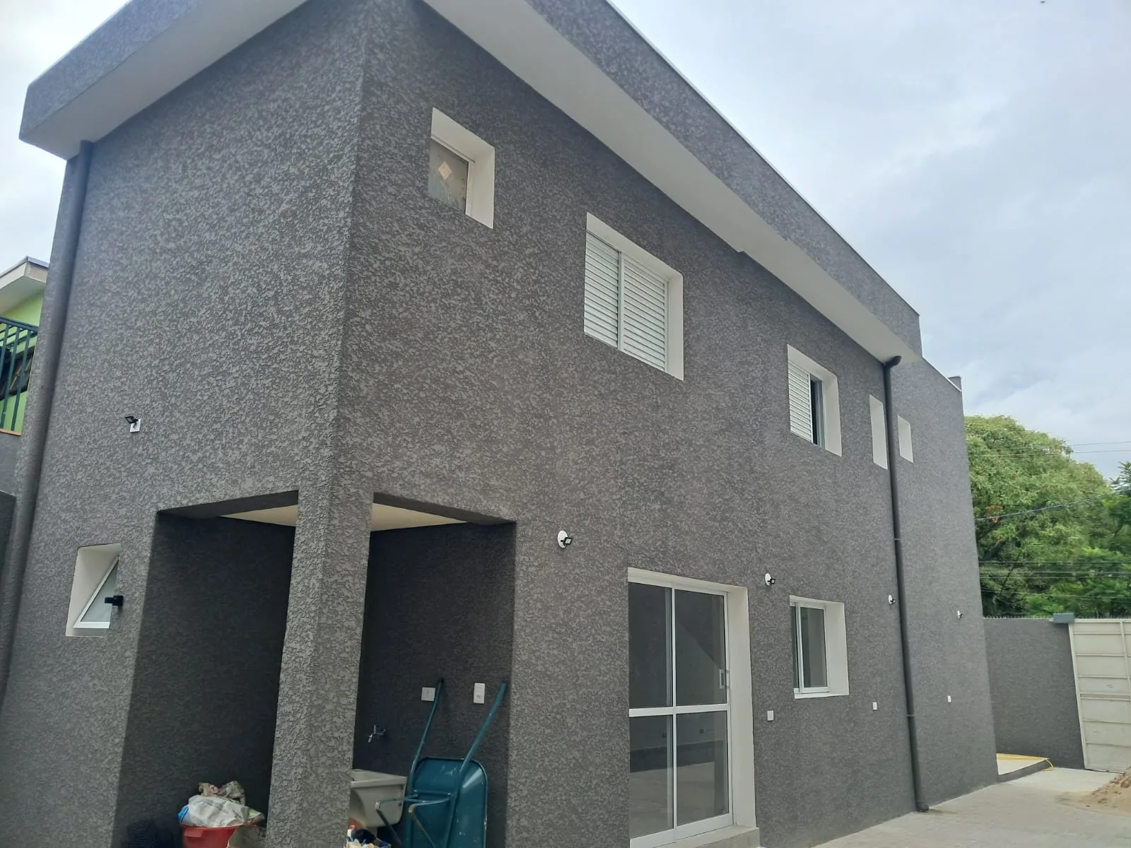 Fachada depois da obra, revestida em textura projetada cinza escuro